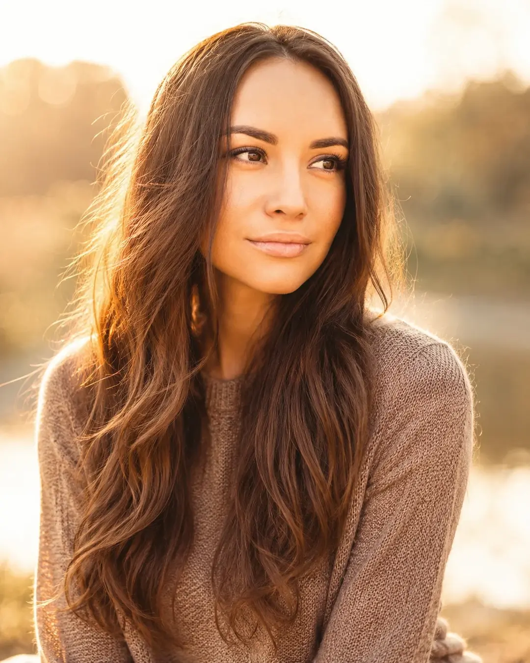 Woman in a sweater outdoors at golden hour
